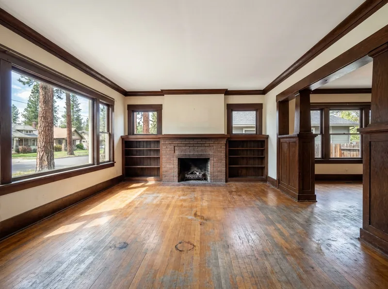 Craftsman living room oak floor with gray traffic lanes, scratches and water rings before refinishing
